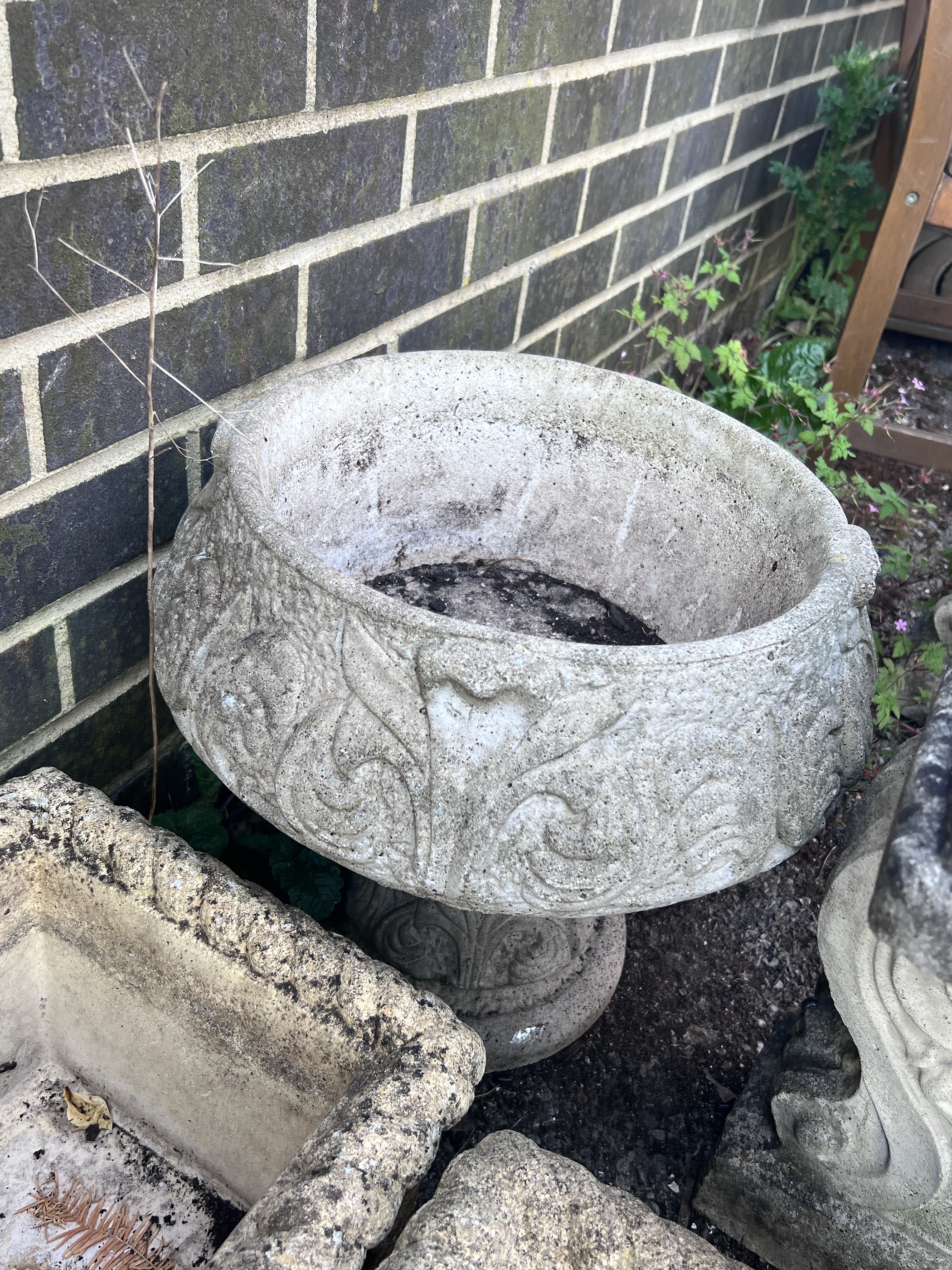 Four reconstituted stone garden planters.
